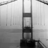 The construction of the Severn Bridge was one of the biggest and most famous achievements of the 1960s motorway programme. Work on the bridge took several years; here the cables have been put in place awaiting the arrival of road deck sections.