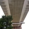 It's clear when looking up that the bridge deck arrived in sections that were slotted together, one after the other, to form a roadway. Each section was towed in by barges on the river and lifted into place.