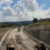 The view south from the overbridge, at another section nearer to completion, with streetlights visible in the distance.