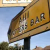 A closer look at the paint peeling from the lower sign shown above.