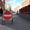 This part of the street is supposed to have traffic to one side and pedestrians across the rest of the road, but without explicit guidance it seems some vehicles have been heading the wrong way, and on the pedestrian side too. That must be why this temporary "no entry" sign is here. To the right, the skylights for the pedestrian tunnel once formed traffic islands.