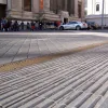 Tactile paving and a drainage channel on the east side of the street marks the edge of the pedestrian footway and the live traffic lanes — where, on a normal street, you'd expect a kerb. This seems sensible; blind pedestrians have adequate warning that they are straying from the safe area.