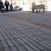 On the opposite side of the street, more tactile paving separates the footway from... another pedestrian area and some seating. Wouldn't this be better placed at the edge of the pedestrian-only zone, and not just where the kerb used to be?