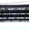 The road deck, seen from below, is hardly a deck at all - it's an open framework of struts and girders supporting four separate decks for traffic and pedestrians. This design makes it lightweight and also reduces the effect of strong winds - though only to the extent that high winds have never damaged the bridge. Throughout its life, the Forth Road Bridge has suffered frequent and problematic closures because of the wind.