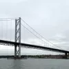 The southern end of the bridge, seen from the west, with South Queensferry behind it, shows the size of the bridge well. Its simple form and lightweight structure are worlds away from the Forth Rail Bridge.