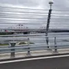 The wind barriers are semi-transparent and offer a slightly distorted view of the Forth Bridge a little further east.