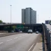 A vision of the future Gateshead once imagined: here is a view looking south from the end of the Highway. Unusually, it rises up as two separate ramps on either side of a dual carriageway. Traffic remaining on a lower level meets a roundabout with the A184; traffic heading up top gets a non-stop rooftop-level journey through to the south end of the town centre.