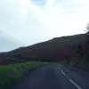 Ahead, the road follows the contour of the hills. Below, to the left, is a very sudden drop into the sea. Steer carefully!