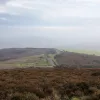 From Porlock Common, there's an opportunity to pull over and see the course of the road snaking across the barren moorland. Here, the road is exposed and windswept, battered by winds coming off the Atlantic and without shelter. Just out of sight, it drops suddenly down to Porlock.