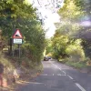 From here to the bottom — a distance of about another half a mile — the gradient is 1 in 4, or in layman's terms, very flipping steep indeed. In front is a car from a motoring school, in which a particularly sadistic driving instructor is giving his pupil a real grounding in hill driving.