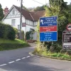The sign at the bottom of the hill, facing drivers about to go up it, is designed to deter those without the confidence or skill to proceed, and in no uncertain terms advises heavy traffic and vehicles with trailers or caravans to take the toll road, which lies to the right.