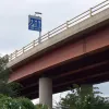The M62-bound viaduct runs at a high level for quite some time, and when it lands again, forms the mainline of the M621. The westbound mainline becomes a sliproad merging in from the left.