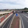 A little further out, traffic merges together bound for the M1. On the left, a single lane sliproad passes underneath the interchange, carrying eastbound traffic to junction 4. On the far right, westbound traffic exits for the city centre.