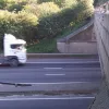 Along the outside, the parapet has several steps to accompany an inward lean. This view also highlights the bridges' inbuilt safety device: when the M1 was opened there were no barriers, so the central pillars are built into a traffic island which is shaped to bounce traffic back into its own carriageway.