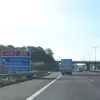 Approaching Watford Gap services, Britain's first motorway service area. The sign proclaims it to be "now fully open", though to the best of my knowledge it has been open since about 1960.