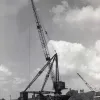Laing numbered each of the bridges along the route to keep track of them all. This is one of the large cranes used on site, seen near bridge 74. 30 May 1958.