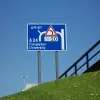 The unfinished exit would have been part of the Brook Street junction, and this sign (now replaced with a larger one, placed on the unfinished sliproad itself) warns drivers of the eastbound exit that does exist: a tight loop to enter Brook Street southbound.
