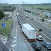 From the same viewpoint as the first image, the heavy traffic shown here is more usual along this route, and the reason for the widening works becomes apparent.