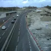 A view away from the viaducts, where the M2 is temporarily realigned onto the newly built London-bound carriageway. The original roadway has seemingly been removed altogether, to be replaced by a new single carriageway. The new coast-bound carriageway here will be as wide as the whole original motorway.