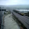 Another view of the train on the line. Working on top of the carriages to fit the overhead cables must have been pretty vertigo-inducing while the train was sat on the viaduct.