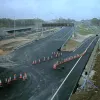 Looking north again, and the new coast-bound carriageway takes shape. Some lane markings are in place while, to the left, the M2 runs entirely on its new London-bound carriageway.