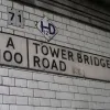 Another example, but this time on two lines. Both this sign and the previous one include the postcode district after the road name, and this used to be painted red. Above this sign is an old-style plate indicating the presence of a fire hydrant. The more modern 71 sign is probably the bridge number. Like many other railway bridges in this part of London, the side walls are covered in white glazed tiles.  Photo by Tony
