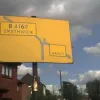 This local road sign is in the West Midlands. Originally the boxes within the sign would have been white-on-black, but the white paint or vinyl has long since departed. Aside from this the sign is in excellent condition, complete with a hint of a white stripe on its pole.  Photo by Richard Barraclough