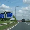 Once a motorway, now a non-primary route, the black-and-white sign at the end says it all.  At the depot, we speak to the head of traffic management who puts us in touch with their signage sub-contractor. We call, wait a while, call back, all the time expecting to have to pay for the sign. It's even possible by this time that it has been scrapped or stripped down to be re-faced.  To our surprise, the contractor's response is to direct us to where his works van is parked at the depot and to help ourselves!
