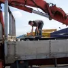 The contractor's van, which is knee-deep in heavy aluminium signs laid on top of each other. The biggest are generally on top, including two enormous "River Mersey" signs that manage to cover the rest. The sign we're looking for is right at the bottom and was only eventually extracted with the help of one of the workers on site.