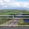 A view to the east again from the middle of the road over the bridge. showing the M62 passing over Scammonden Dam. In the distance it passes into a cutting that, anywhere else, would be the biggest for miles around.