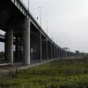 From the west, a wonderful view, with the streetlights marching away down the side and a very graceful curve into the distance. Two sets of what seem to be new piers, free of scaffolding, can be seen here.