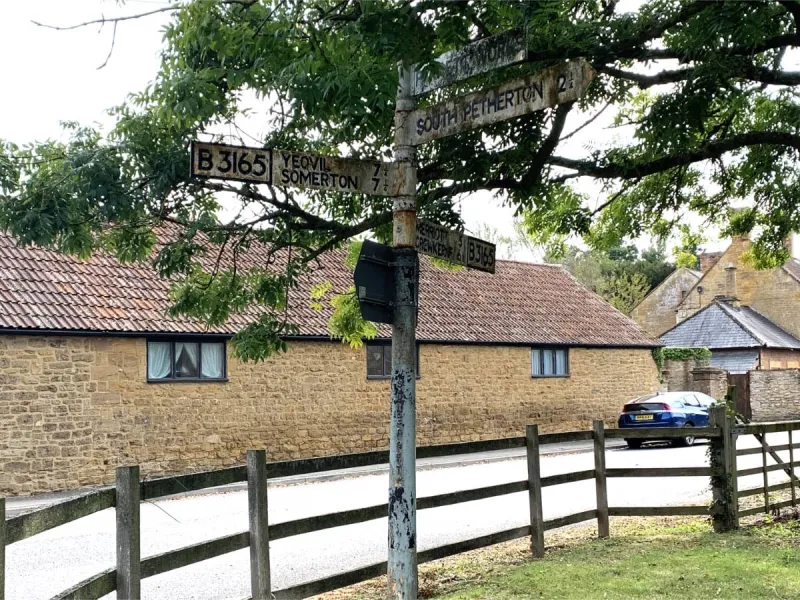 The town of Martock is near the valley of the River Parrett, and the B3165 indicated here roughly runs along the valley for a short way between here and Long Load, near Langport. When originally installed the B-road number would have been in white on black, but the colours would have been reversed when repainted in the 1950s or 60s.