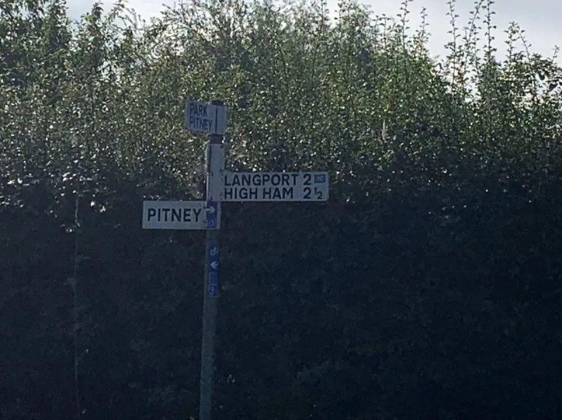 Here in the hamlet of Pitney, a modern signpost has been erected in the style of an old fingerpost, but it hasn't been done very convincingly. Its authenticity is not helped by the bicycle stickers.