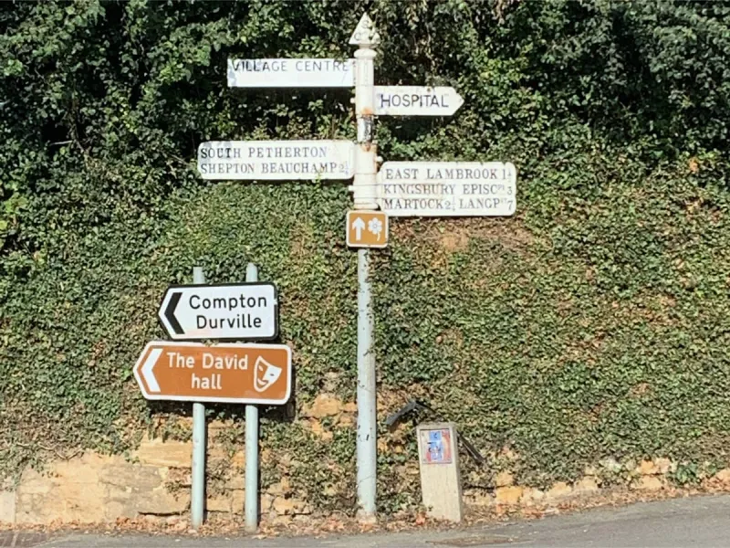 Just down the road from the previous sign is this oddity. The serif lettering seems to be original, as it’s painted upon raised letters like the others. It’s harder to read, but very picturesque.