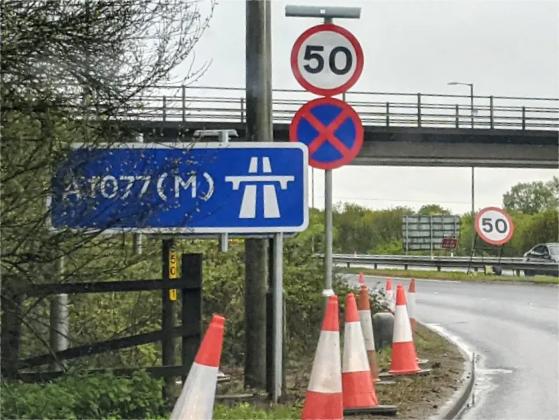 If we spin around the terminal roundabout to head south again, here's the former start of the M181. The new A1077(M) sign is placed in front of the old M181 sign, just visible behind it.